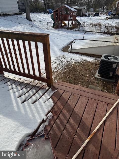 snow covered deck featuring cooling unit