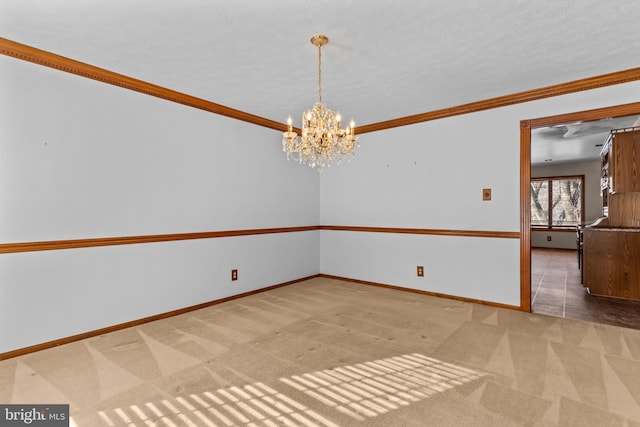 carpeted empty room with ornamental molding and a chandelier