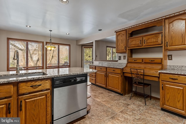 kitchen with plenty of natural light, sink, stainless steel dishwasher, and decorative light fixtures