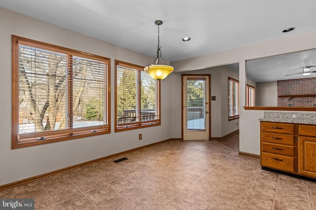 unfurnished dining area featuring ceiling fan