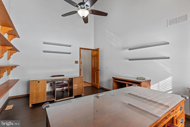 office with a towering ceiling and ceiling fan