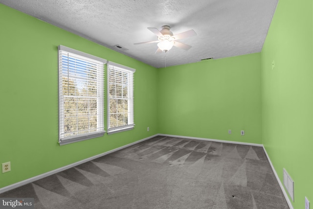 unfurnished room with ceiling fan, carpet floors, and a textured ceiling