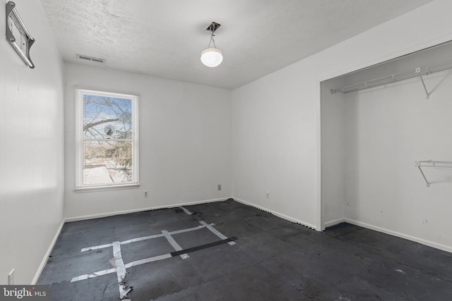 interior space with a closet and a textured ceiling