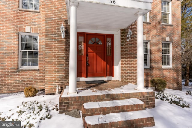 view of snow covered property entrance