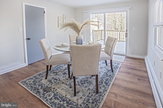 dining room featuring hardwood / wood-style floors and a baseboard heating unit