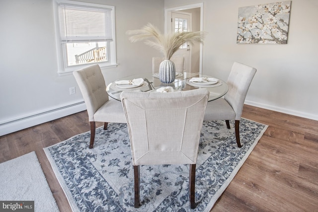 dining room with hardwood / wood-style floors and baseboard heating