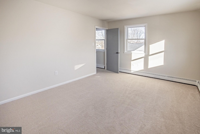 carpeted spare room featuring a baseboard radiator