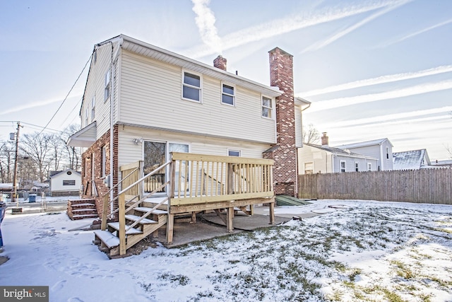 snow covered property featuring a deck