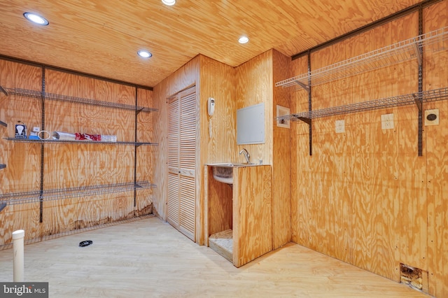 interior space with hardwood / wood-style flooring, wooden ceiling, and wooden walls