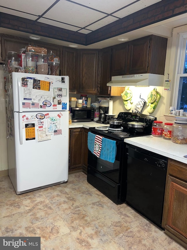 kitchen featuring dark brown cabinetry and black appliances