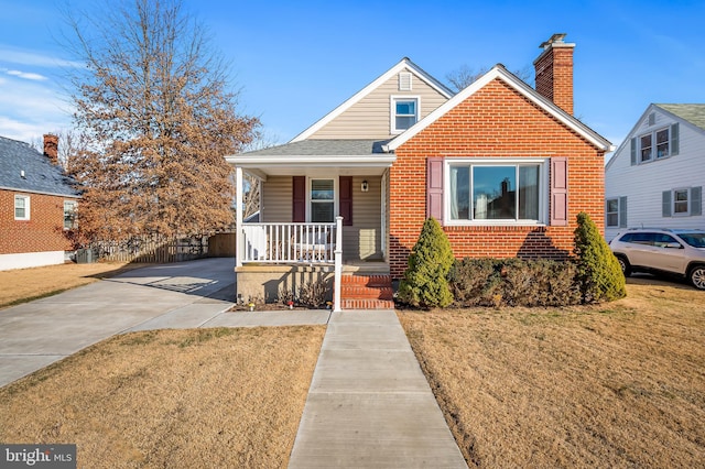 bungalow-style house with a porch and a front lawn