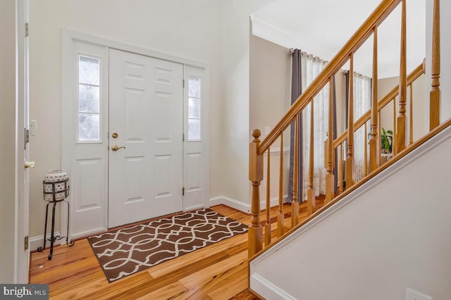 entryway with hardwood / wood-style floors