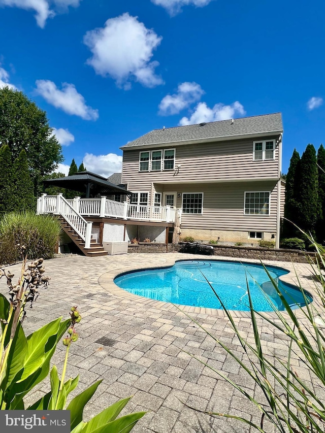 view of swimming pool featuring a patio and a deck