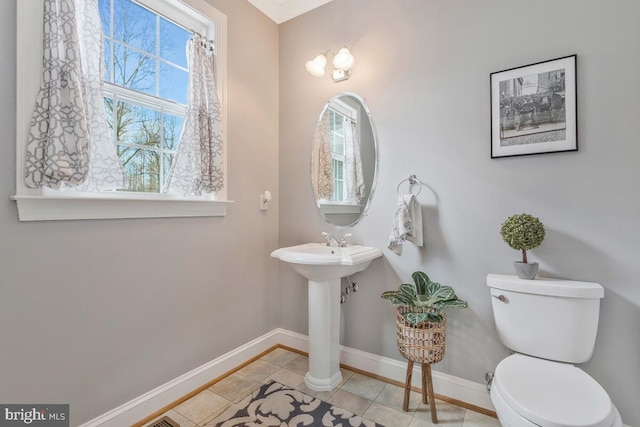 bathroom featuring toilet and tile patterned flooring