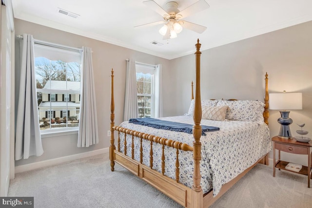 bedroom with ceiling fan, ornamental molding, and light carpet