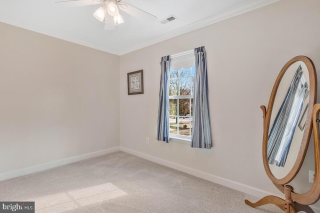 carpeted empty room featuring crown molding and ceiling fan