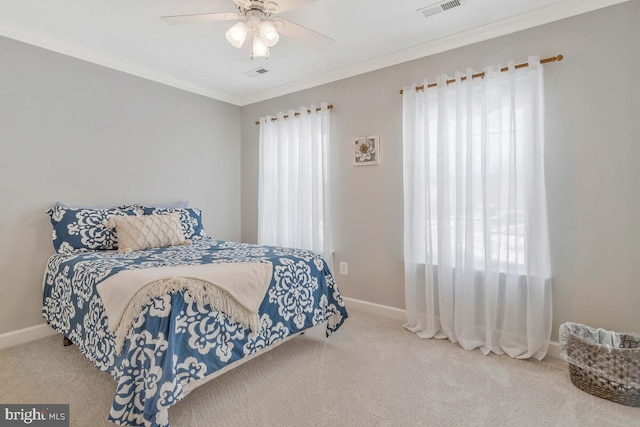 bedroom with ceiling fan, ornamental molding, and carpet