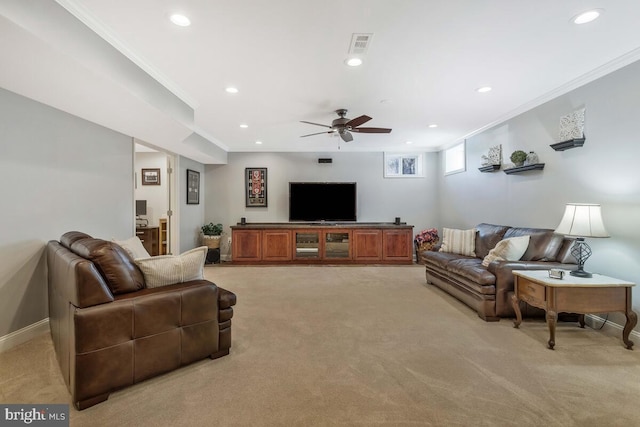 living room featuring crown molding, ceiling fan, and light carpet