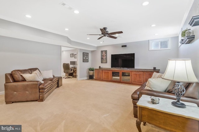 living room with crown molding, light colored carpet, and ceiling fan