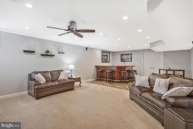 carpeted living room featuring ceiling fan and indoor wet bar