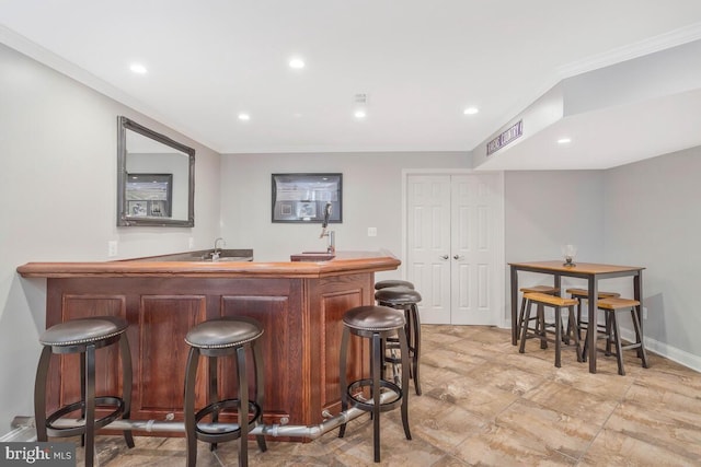 bar featuring sink and ornamental molding