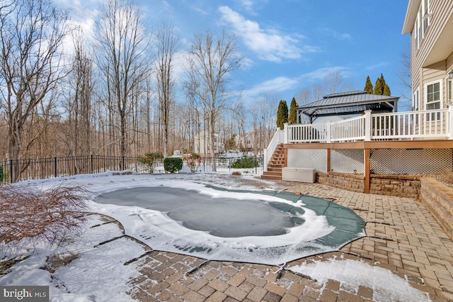 yard layered in snow with a gazebo, a deck, and a jacuzzi