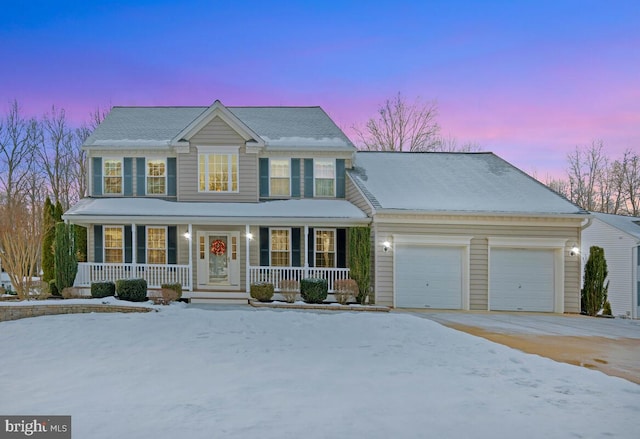 colonial home featuring a garage and covered porch