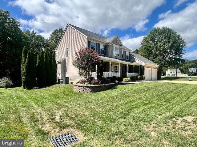 view of front of house with central AC, a porch, a garage, and a front lawn