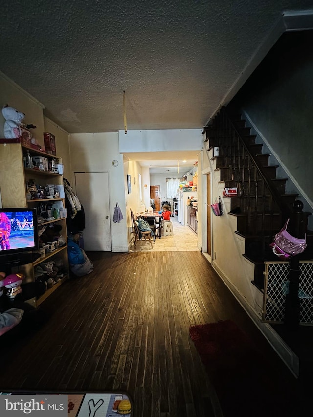 interior space with hardwood / wood-style flooring and a textured ceiling