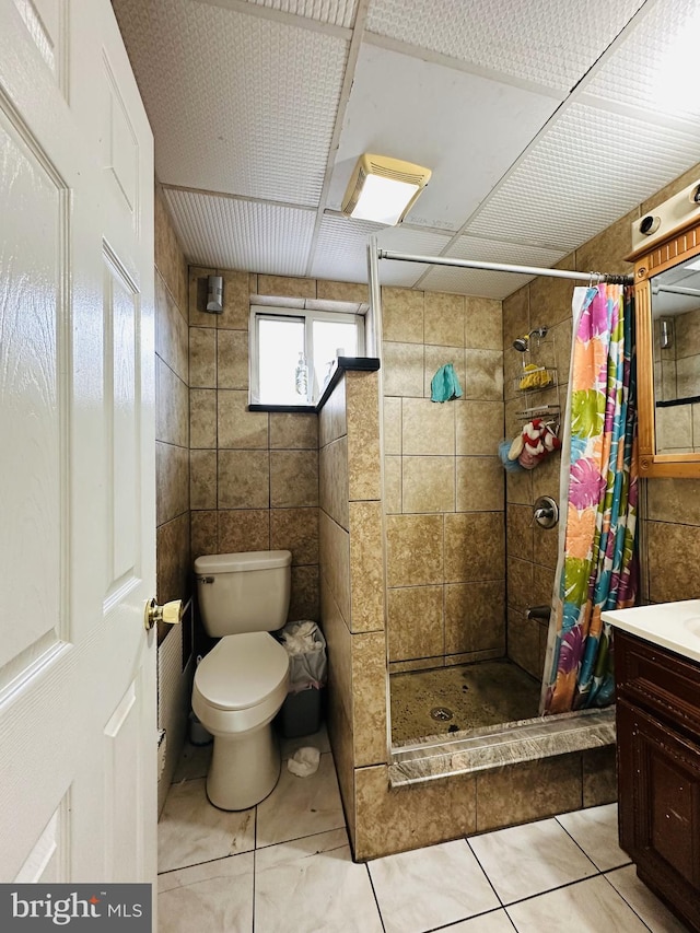 bathroom with a shower with shower curtain, vanity, toilet, and tile patterned flooring