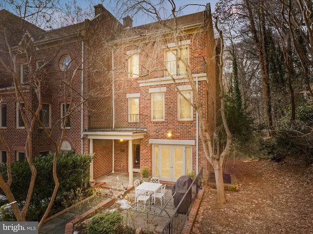 rear view of house featuring french doors and a patio area