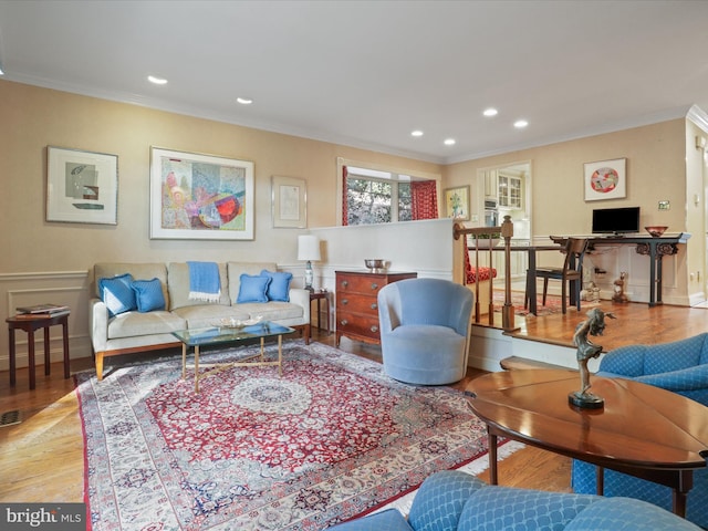 living room with crown molding and light hardwood / wood-style floors