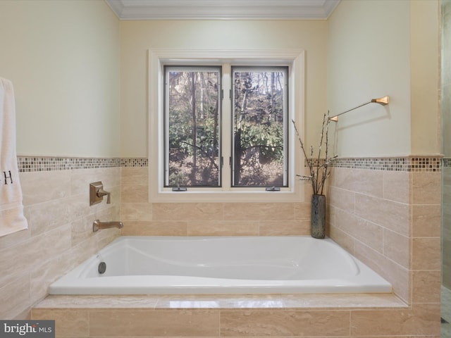 bathroom with tiled tub and ornamental molding