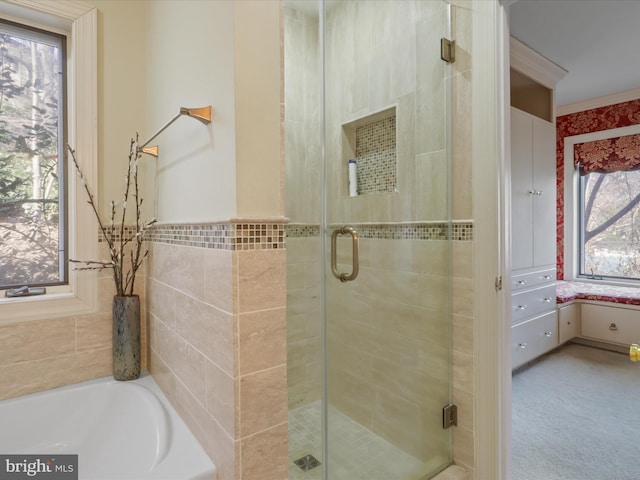 bathroom featuring independent shower and bath and tile walls