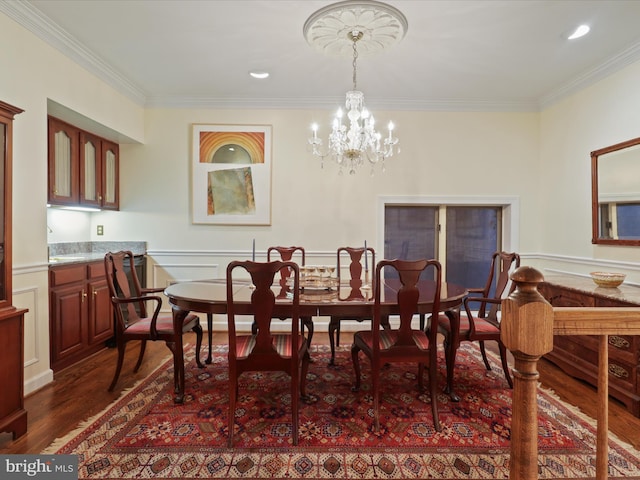 dining space with ornamental molding, dark hardwood / wood-style floors, and a notable chandelier