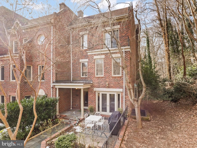 back of property with french doors and a patio