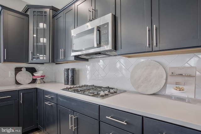 kitchen with backsplash and appliances with stainless steel finishes