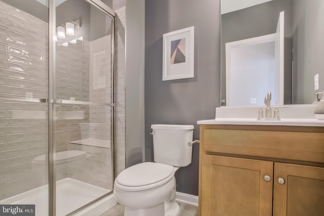 bathroom with vanity, an enclosed shower, and toilet