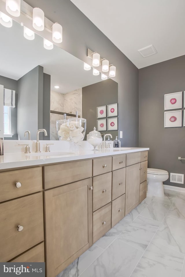 bathroom featuring vanity and toilet