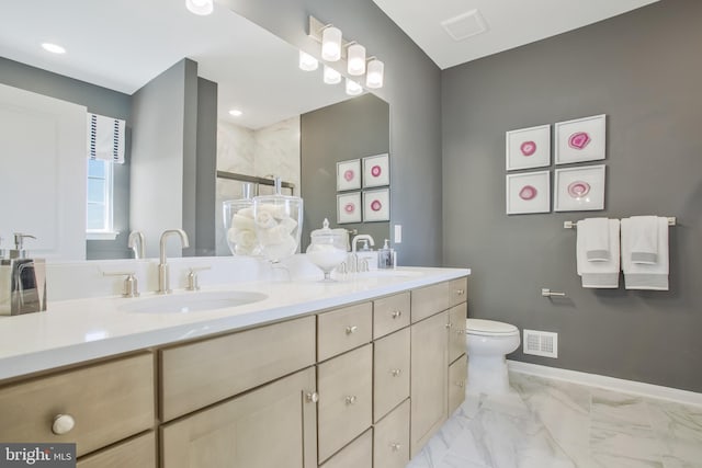 bathroom featuring vanity, toilet, and a shower