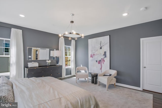 bedroom featuring dark wood-type flooring and a notable chandelier