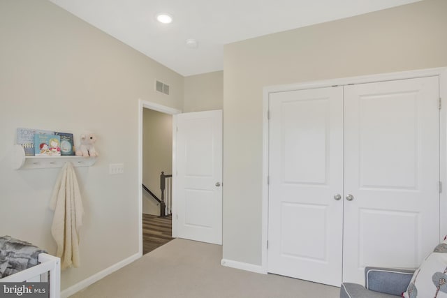 bedroom with carpet and a closet