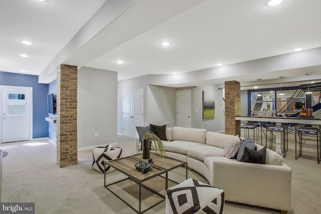 carpeted living room featuring decorative columns