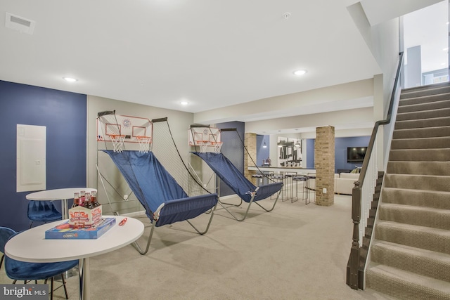 recreation room featuring electric panel and carpet