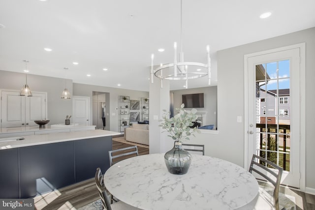 dining area featuring dark hardwood / wood-style floors, a wealth of natural light, and a chandelier