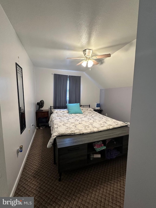 bedroom featuring lofted ceiling, a textured ceiling, and ceiling fan