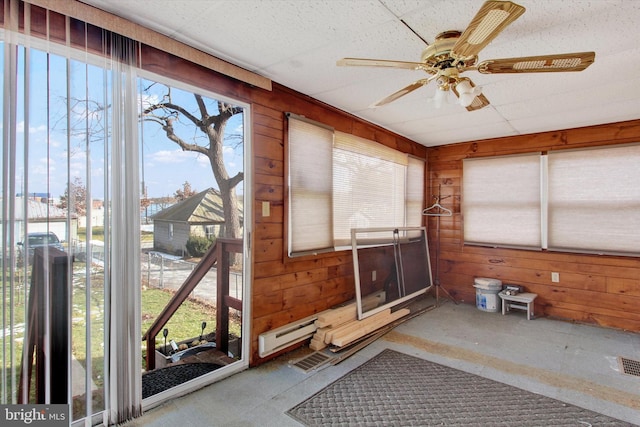 sunroom / solarium featuring ceiling fan and baseboard heating