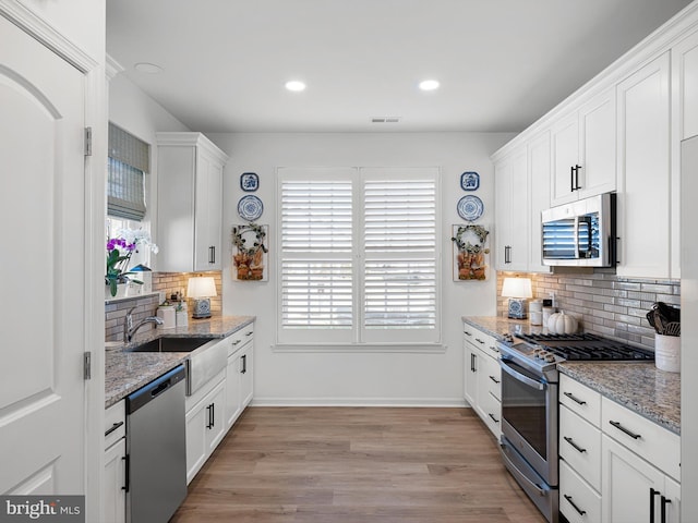 kitchen featuring sink, white cabinets, and appliances with stainless steel finishes