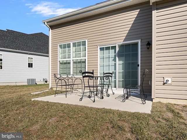 exterior space featuring a yard, central AC unit, and a patio