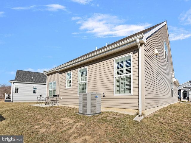 back of house with a patio, central AC unit, and a lawn